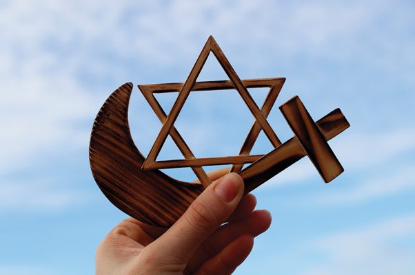 Christianity, Islam, Judaism  3  monotheistic religions. Jewish  Star, Cross and Crescent :  Interreligious symbols in hand. (Photo by: Godong/Universal Images Group via Getty Images)